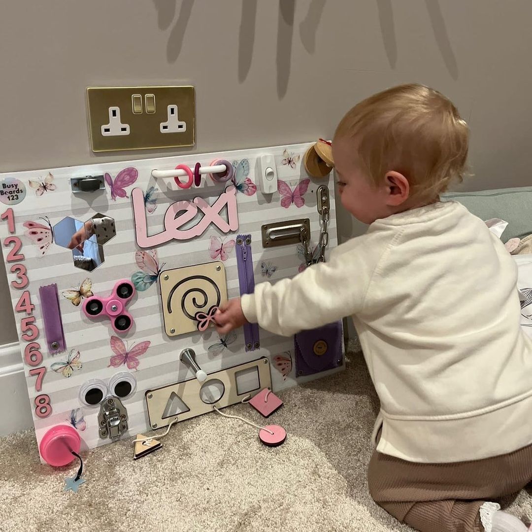 Toddler Playing on a Busy Board