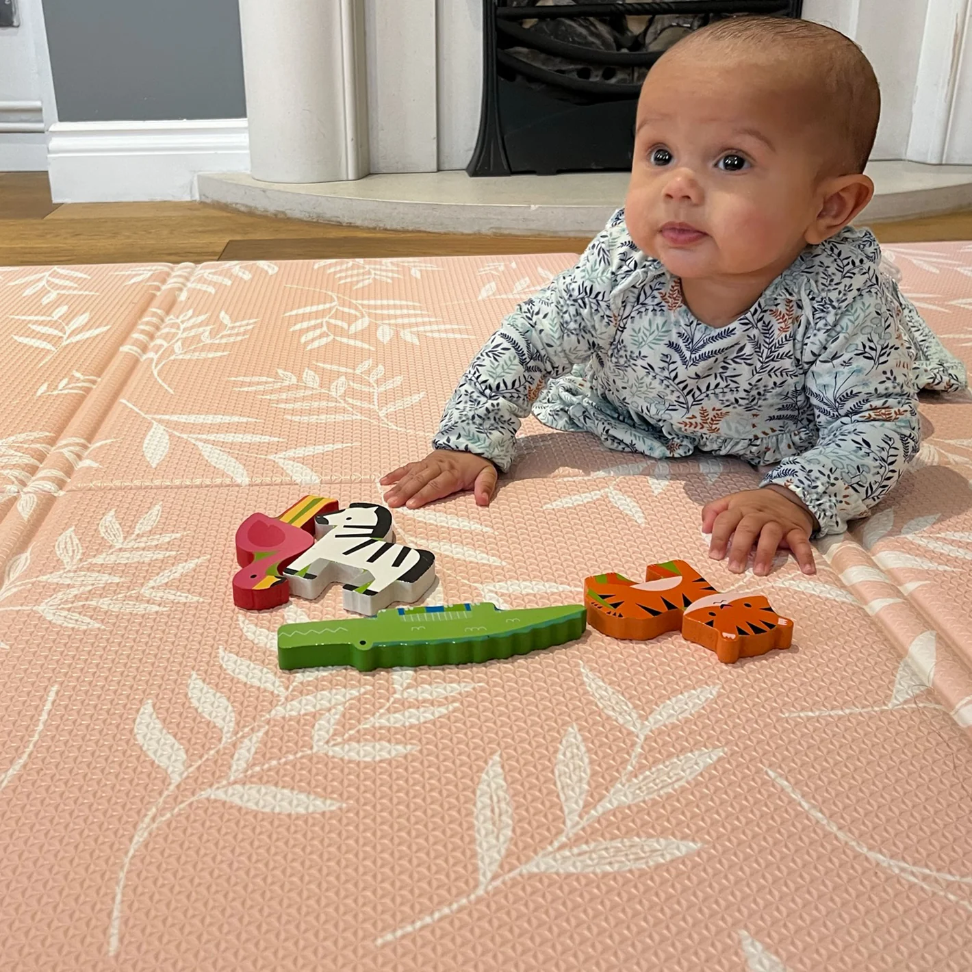 baby on pink playmat
